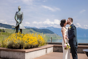 The newlyweds kissing near the beds of yellow flowers