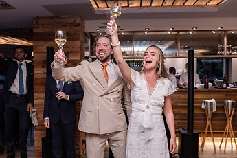 The couple raising their glasses