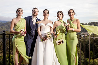 The newlyweds and three friends in green dresses, on the terrace