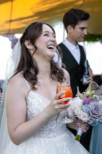 Lucie laughs, a spritz in her hand