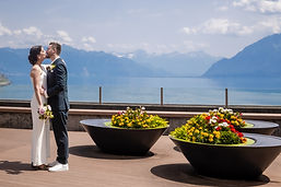 The couple kissing on the flower-filled terrace