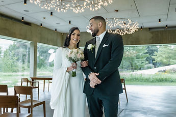 Leila and Marouan alone in the room, in front of the large windows