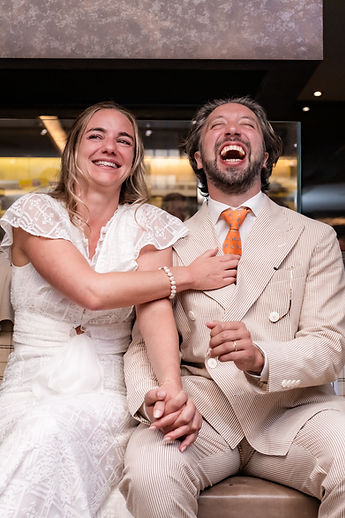The couple laughing, hand in hand