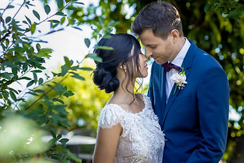 Close portrait of the couple amid the greenery