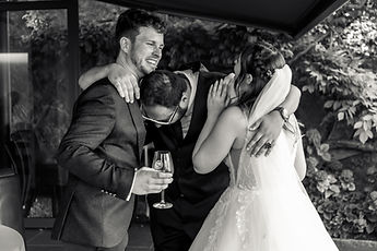 Hugs as the couple arrive, in black and white