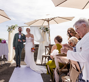 The couple walk back up the aisle between their loved ones