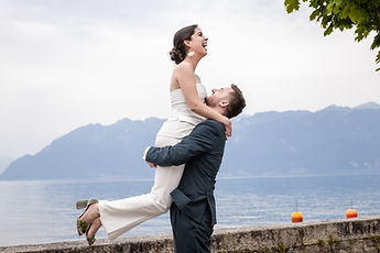 Jean lifting Gemma, facing the lake