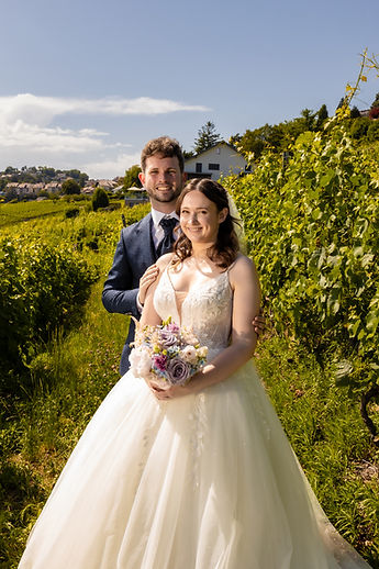 Lucie and Patrick smiling between the vines