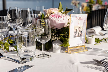 Table detail: glasses, peonies and table number