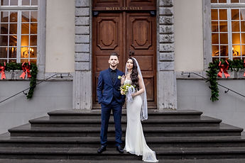 The couple in front of the façade and its lit windows
