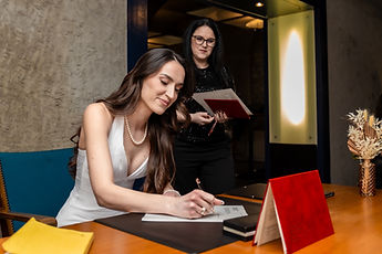 Albina signing the register