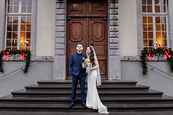 Leonora and Mersim on the front steps, the door of the Hôtel de Ville behind them