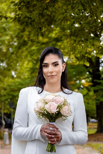Leila, gazing straight ahead, her bouquet held close