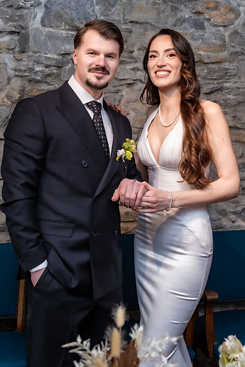 Albina and Diamant in front of the room's stone wall