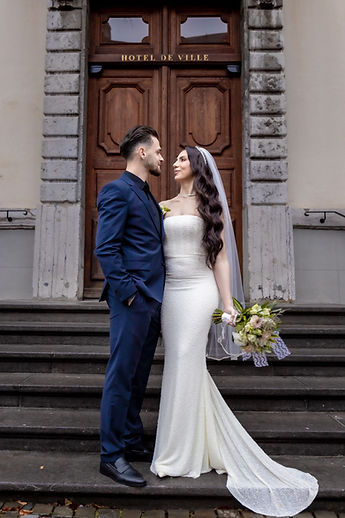 The newlyweds embracing in front of the door