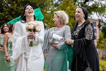 Leila, bouquet in hand, with two guests