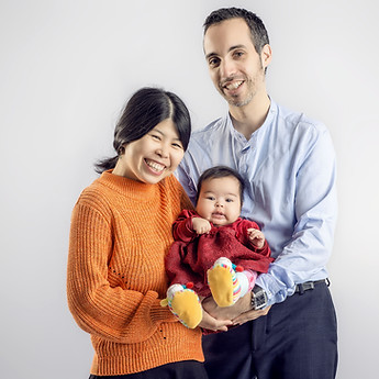 Parents standing with their baby in their arms