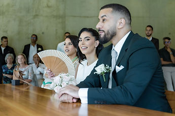 Marouan in profile, Leila behind her fan