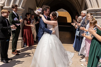 Lucie and Patrick embracing, surrounded by their guests