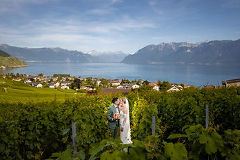 Wide view over Lavaux and Lake Geneva, the couple among the vines