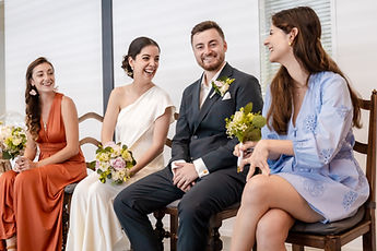Gemma and Jean seated during the civil ceremony, with two loved ones beside them
