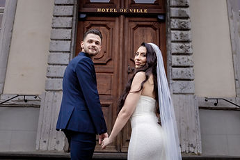 Hand in hand, the newlyweds looking back with a smile