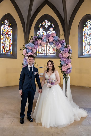 The flower arch, the stained glass and the couple