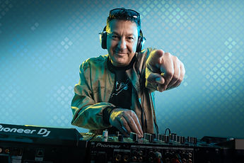Studio portrait of a DJ pointing at the camera