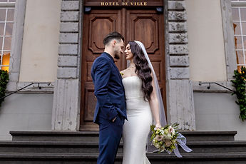 The newlyweds kissing on the front steps