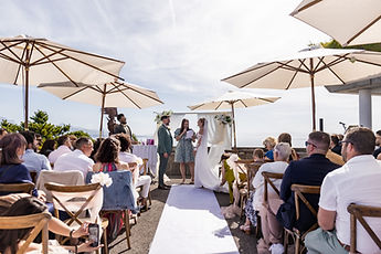 Wide view of the secular ceremony on the terrace, beneath the parasols