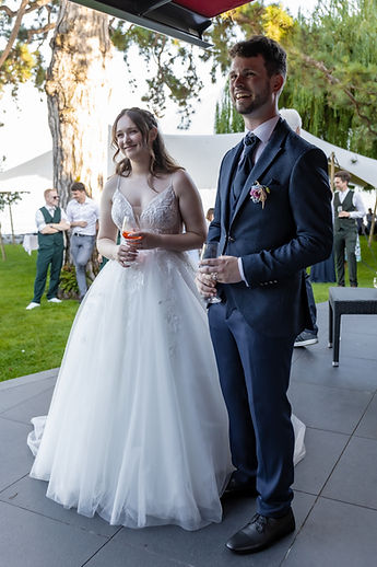 Lucie and Patrick arrive on the terrace, glass in hand