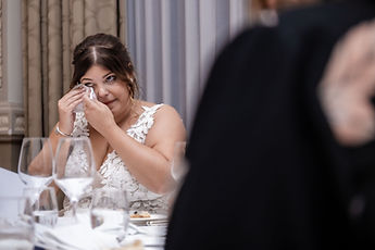 Sabrina wiping away a tear during a speech