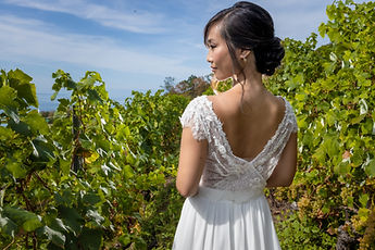Liliane from behind, looking towards the vines