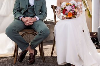 Detail: the bouquet resting on the bride's lap