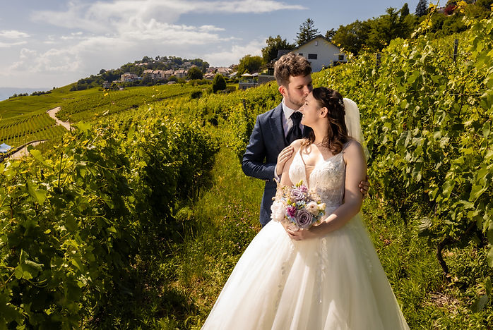 Patrick kisses Lucie on the forehead in the Lavaux vineyards