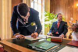 Maxime signing the register