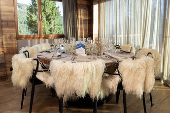 The dinner room, chairs draped with sheepskins