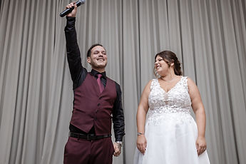 Idrisse raising the microphone, Sabrina laughing