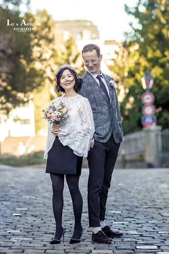 The couple, full length, on a cobbled street near the cathedral
