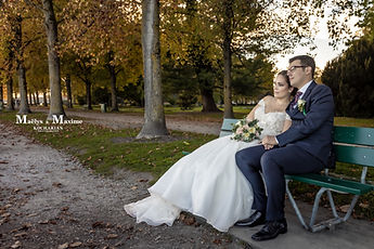The newlyweds sitting on a park bench