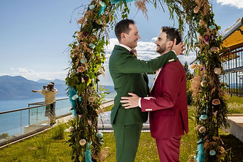 A tender gesture beneath the arch, facing the lake