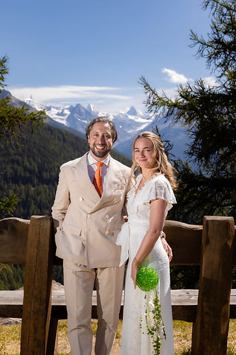 The couple standing by the bench