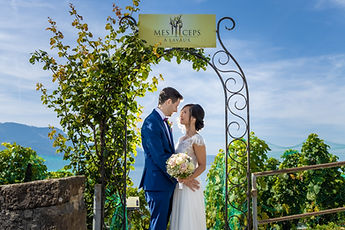 Liliane and Antoine under a vine-covered arch in Chexbres