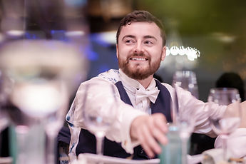 Jean laughs at the table, behind the glasses