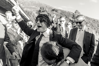 A guest carried by his friends, in black and white