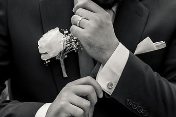 Black-and-white detail: Marouan's boutonniere and wedding ring