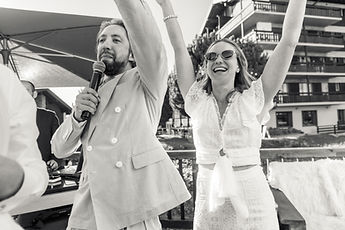 Derek at the microphone, Charlotte with her arms raised
