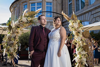 The couple under the arch, in front of the Lausanne Palace façade