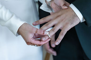 Detail: the couple's hands and their rings