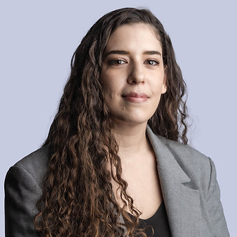Portrait of a woman with long curly hair in a grey jacket